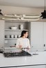 Modern home with Kitchen, Wall Oven, Refrigerator, Cooktops, Undermount Sink, Pendant Lighting, and Concrete Floor. Kitchen view with Hygge Supply cabinets. Photo 4 of North Shore #7