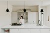 Modern home with Kitchen, Pendant Lighting, Cooktops, Refrigerator, Engineered Quartz Counter, Concrete Floor, Undermount Sink, Dishwasher, and Wall Oven. Kitchen view Photo 13 of North Shore #7