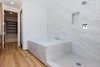 Modern home with Bath Room, Medium Hardwood Floor, Quartzite Counter, Undermount Sink, Drop In Tub, Whirlpool Tub, Full Shower, Enclosed Shower, Ceiling Lighting, Porcelain Tile Wall, and One Piece Toilet. Master Bath with dual shower heads including rain head / jet tub Photo 4 of Mammoth Modern House 1