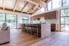 Modern home with Kitchen, Engineered Quartz Counter, Quartzite Counter, Wood Cabinet, Medium Hardwood Floor, Ceiling Lighting, Pendant Lighting, Range, and Undermount Sink. Seating for 5 at the large island counter Photo 11 of Mammoth Modern House 1