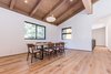 Modern home with Dining Room, Table, Chair, Medium Hardwood Floor, Standard Layout Fireplace, Ceiling Lighting, and Pendant Lighting. A big enough dining space that can serve as a flex area with added seating or lounging. Photo 12 of Mammoth Modern House 1