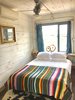 Modern home with Bedroom, Bed, Bookcase, Night Stands, Shelves, Storage, Ceiling Lighting, and Dark Hardwood Floor. We use luxury linens from Pandora de Baltazar and Matteo in every one of our Houzes Photo 6 of Flophouze Hotel