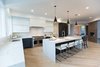 Modern home with Kitchen, Engineered Quartz Counter, Quartzite Counter, White Cabinet, Wood Cabinet, Light Hardwood Floor, Ceiling Lighting, Dishwasher, Pendant Lighting, Accent Lighting, Refrigerator, Microwave, Cooktops, Range, Range Hood, and Drop In Sink. Sea Star Kitchen - After Photo 4 of Sea Star - Modernization Transformation