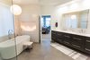 Modern home with Bath Room, Engineered Quartz Counter, Quartzite Counter, Freestanding Tub, Open Shower, Accent Lighting, Porcelain Tile Floor, Wall Mount Sink, Ceiling Lighting, Pendant Lighting, Porcelain Tile Wall, and One Piece Toilet. Sea Star Master Bathroom - After Photo 4 of Sea Star Master Bathroom - Hidden Potential