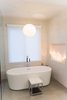 Modern home with Bath Room, Freestanding Tub, Porcelain Tile Floor, Porcelain Tile Wall, Ceiling Lighting, Accent Lighting, Pendant Lighting, and Open Shower. Sea Star Master Bathroom - After Photo 2 of Sea Star Master Bathroom - Hidden Potential
