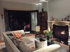 Modern home with Living Room, Floor Lighting, Sofa, Ceiling Lighting, Coffee Tables, Wood Burning Fireplace, and Medium Hardwood Floor. Living room - doors open to front patio - antique marble mantle Photo of The Joseph House