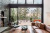 Modern home with Living Room, Concrete Floor, Ceiling Lighting, Sectional, Coffee Tables, Recessed Lighting, Chair, Accent Lighting, Wood Burning Fireplace, and Standard Layout Fireplace. Indoor-outdoor living rooms Photo 8 of The Greenhills House