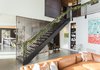Modern home with Living Room, Bookcase, Accent Lighting, Pendant Lighting, Ceiling Lighting, Recessed Lighting, Chair, Concrete Floor, and Sectional. Entry stair Photo 9 of The Greenhills House