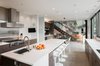 Modern home with Recessed Lighting, Concrete Floor, Pendant Lighting, Ceiling Lighting, and Accent Lighting. Kitchen and dining with living room beyond Photo 12 of The Greenhills House