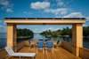 Modern home with Exterior, Boathouse Building Type, Metal Roof Material, and Wood Siding Material. View from the top deck Photo of The Barge Yacht