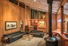 Modern home with Living Room, Ceiling Lighting, Bookcase, Pendant Lighting, Porcelain Tile Floor, and Wood Burning Fireplace. Living Room at night. Photo 7 of The House of the Falling Moon