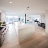 Modern home with Kitchen, Range, Range Hood, Stone Counter, White Cabinet, Light Hardwood Floor, Stone Tile Backsplashe, Ceiling Lighting, and Undermount Sink. Kitchen and Dining Room Photo 6 of Webster Terrace