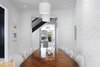 Modern home with Dining Room, Chair, Table, Ceiling Lighting, and Light Hardwood Floor. Dining Room Photo 2 of (re) Edwardian House by Post Architecture Inc.