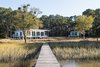 Modern home with Exterior, Green Roof Material, Mid-Century Building Type, Prefab Building Type, Green Siding Material, Flat RoofLine, Wood Siding Material, Metal Roof Material, and Metal Siding Material. Front facade - Main house, guest house Photo of The Beatty Home