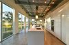 Modern home with Kitchen, Concrete Floor, Dishwasher, Range Hood, Wall Oven, Refrigerator, Cooktops, Ice Maker, Ceiling Lighting, White Cabinet, Engineered Quartz Counter, and Undermount Sink. Kitchen Photo 3 of The Beatty Home