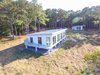 Modern home with Exterior, Wood Siding Material, Green Roof Material, Prefab Building Type, Flat RoofLine, Green Siding Material, Metal Siding Material, Metal Roof Material, and Mid-Century Building Type. Rear facade - main house, guest house Photo 12 of The Beatty Home