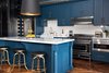 Modern home with Kitchen, Metal Counter, Marble Counter, Tile Counter, Colorful Cabinet, Wood Cabinet, Medium Hardwood Floor, Microwave, Subway Tile Backsplashe, Pendant Lighting, Refrigerator, Range, and Beverage Center. Kitchen: Collaboration between Kraig Kalashian Architecture & Design and Garret & Garage
Floor: Herringbone wood floor by Havwoods
Support columns with built-in wine rack: Designed by Garret & Garage, blackened steel with brass buttons
Kitchen cabinets & island paint: Farrow & Ball color “Stiffkey Blue”
Range: Bertazzoni, Heritage Series, Italy
Refrigerator: Viking
Sink: Rohl Shaw Farm apron sink
Faucet: Perrin & Rowe Photo 20 of Eastern Columbia Loft