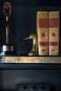 Modern home with Living Room and Bookcase. Bookshelf detail - a Clio award sits next to vintage books, brass detail bookshelf corner element Photo 14 of Eastern Columbia Loft