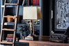 Modern home with Living Room, Bookcase, and Table Lighting. Desk Lamp:
Fuller Brush Man by Garret & Garage
Brass, walnut, leather, rawhide lampshade
Art Frame:
Hair on hide from House of Mercier, Peru
Photo 3 of Eastern Columbia Loft