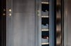 Modern home with Kitchen and Beverage Center. Support column with built-in wine rack: Designed by Garret & Garage, in blackened steel with brass buttons Photo 19 of Eastern Columbia Loft