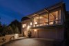 Modern home with Exterior, House, and Wood Siding Material. Rear exterior, the bank of windows have views of palm trees and slices of the Bay and San Francisco. Photo of Vintage Hollywood in the Berkeley Hills
