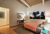 Modern home with Bedroom, Light Hardwood Floor, and Wall Lighting. One of the bedrooms at dusk Photo 2 of Vintage Hollywood in the Berkeley Hills