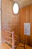 Modern home with Staircase, Wood Railing, and Wood Tread. Stairwell that leads down to the rumpus room, garage and large utility room. Photo 10 of Vintage Hollywood in the Berkeley Hills