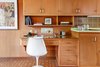 Modern home with Kitchen, Tile Counter, Wood Cabinet, Vinyl Floor, Refrigerator, Cooktops, and Wall Oven. Quintessential mid-century built-in desk in the kitchen Photo 11 of Vintage Hollywood in the Berkeley Hills