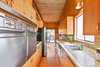 Modern home with Kitchen, Vinyl Floor, Wall Lighting, Refrigerator, Wall Oven, Cooktops, and Tile Counter. Side by side GE ovens were lovingly used and preserved Photo 13 of Vintage Hollywood in the Berkeley Hills