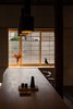 Modern home with Dining Room, Table, Painted Wood Floor, Chair, and Pendant Lighting. A fixed oak dining table is supported from the building structure, allowing it to almost float in space. Photo 7 of Ichijoji House