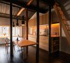 Modern home with Dining Room, Painted Wood Floor, Wall Lighting, Recessed Lighting, Chair, Pendant Lighting, Storage, Bench, Shelves, and Table. From the stained wallpaper, to the lacquered floorboards, to the timber joinery, every element has been hand finished using traditional techniques. Photo 5 of Ichijoji House
