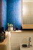 Modern home with Bath Room, Porcelain Tile Floor, Open Shower, Wood Counter, Wall Mount Sink, Recessed Lighting, Wall Lighting, Accent Lighting, and Ceramic Tile Wall. Lacquered wallpapers bring a vibrancy of colour to the bathroom. Photo 10 of Ichijoji House