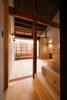 Modern home with Living Room, Light Hardwood Floor, and Wall Lighting. An unconventional application of traditional techniques and materials has allowed for the retention and enhancement of much of the home’s traditional character. Photo of Ichijoji House