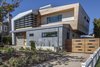 Modern home with Exterior, House Building Type, Wood Siding Material, Stone Siding Material, and Stucco Siding Material. front of house Photo of Legal House