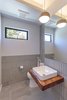 Modern home with Bath Room, Wood Counter, Porcelain Tile Floor, Vessel Sink, Accent Lighting, Ceramic Tile Wall, One Piece Toilet, and Pendant Lighting. powder room Photo 8 of Legal House