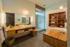 Modern home with Bath Room, Wood Counter, Concrete Floor, Vessel Sink, Pendant Lighting, Stone Tile Wall, Enclosed Shower, Full Shower, and Corner Shower. Master Bath Photo 5 of High Desert Pavillion