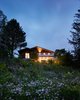 Modern home with Exterior, Cabin Building Type, Wood Siding Material, and Gable RoofLine. View from pond below. Photo of Hockley Valley Chalet Renovation