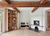 Modern home with Living Room, Bench, Bookcase, Light Hardwood Floor, Slate Floor, and Wood Burning Fireplace. View of Living Room Photo 5 of Hockley Valley Chalet Renovation