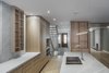 Modern home with Kitchen, Undermount Sink, Wood Cabinet, Stone Slab Backsplashe, Refrigerator, Light Hardwood Floor, Pendant Lighting, and Marble Counter. View of kitchen and hallway Photo 3 of North Toronto Addition