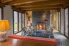Modern home with Living Room, Chair, Lamps, Ceiling Lighting, Table Lighting, Table, Limestone Floor, and Wood Burning Fireplace. Living room from the south Photo 12 of Deep Cove House