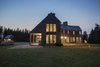 Modern home with Exterior, Shingles Roof Material, House Building Type, Wood Siding Material, and Gable RoofLine. West facade (dining room, guest bedroom) at night Photo 17 of Deep Cove House