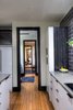 Modern home with Medium Hardwood Floor. Mid-Century architectural influences are evidenced in the open floor plan where living spaces flowing freely from one room to another, “We wake up on the east side of the house with beautiful morning sun in the bedroom suite, and the sun follows us all day through the sunning deck, the service areas, until the evening, when we end up in the western area of the house, where the outdoor living room, fire-pit are located” says Kara Plumb, designer, builder and current homeowner. Photo 18 of Bentley Longhouse