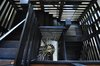 Modern home with Staircase, Wood Tread, and Wood Railing. A dramatic free standing staircase is emphasized by the light from windows used on the adjoining outdoor rooms. The main level of the house is poured slab concrete and leads directly to the outdoor areas, Designed to allow for indoor-outdoor traffic without cross-room confusion. Photo 6 of Bentley Longhouse