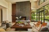Modern home with Living Room, Coffee Tables, Recessed Lighting, Bench, Sofa, Light Hardwood Floor, Ceiling Lighting, Gas Burning Fireplace, End Tables, and Chair. Main living room view. Photo 10 of Bent Tree Residence