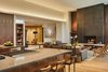 Modern home with Living Room, Light Hardwood Floor, Gas Burning Fireplace, Sofa, Bench, Chair, Bookcase, Ceiling Lighting, and Coffee Tables. Main living area of home, taken from the kitchen. Photo 9 of Bent Tree Residence
