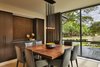 Modern home with Dining Room, Chair, Table, Pendant Lighting, and Limestone Floor. Formal dining room with view of entry water feature. Photo 17 of Bent Tree Residence