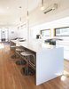 Modern home with Kitchen, Engineered Quartz Counter, White Cabinet, Light Hardwood Floor, Ceramic Tile Backsplashe, Pendant Lighting, and Range. Kitchen Photo 3 of The Gilmore House