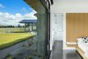 Modern home with Concrete Floor. Floor to Ceiling Glass, Stabilized Gravel and Native Grass Landscaping Photo 15 of The Landing