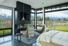 Modern home with Chair, Pendant Lighting, Ceiling Lighting, Recessed Lighting, and Concrete Floor. Ortal Fireplace in Master Bedroom Photo 16 of The Landing