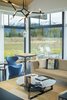 Modern home with Living Room, Sofa, Chair, Coffee Tables, Ceiling Lighting, Recessed Lighting, Pendant Lighting, and Concrete Floor. Bringing the Outdoors in Photo 9 of The Landing